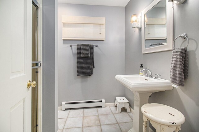 bathroom with tile patterned flooring, baseboard heating, and toilet