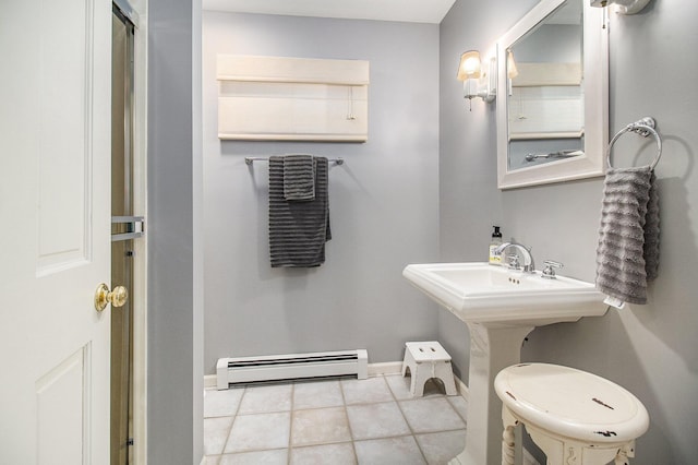 bathroom featuring a baseboard radiator, baseboards, and tile patterned flooring