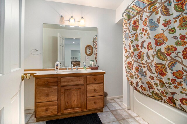 bathroom featuring vanity, tile patterned floors, and shower / tub combo