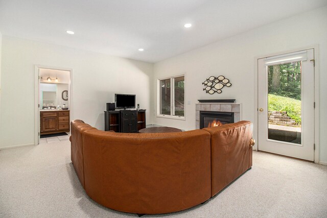 living room with a fireplace and light carpet