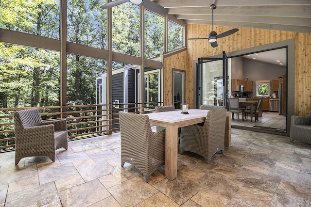 sunroom with lofted ceiling with beams and ceiling fan