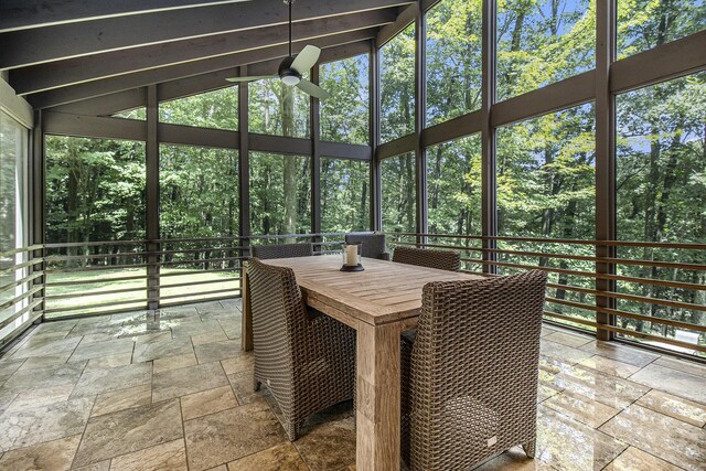 sunroom / solarium with plenty of natural light, vaulted ceiling, and ceiling fan