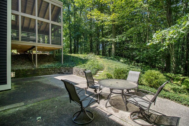 view of patio with a sunroom