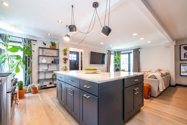 kitchen with stove, pendant lighting, light hardwood / wood-style floors, light stone countertops, and a center island