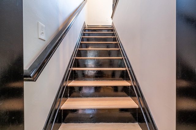 stairway featuring wood-type flooring