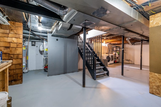 basement featuring washer and clothes dryer and water heater