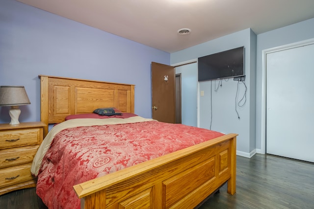 bedroom featuring dark hardwood / wood-style flooring and a closet