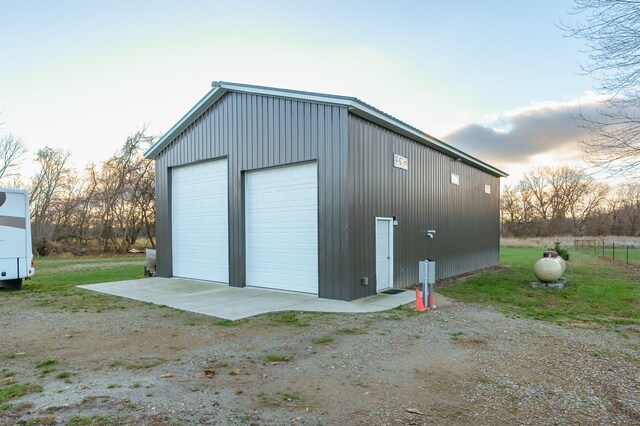 view of garage at dusk