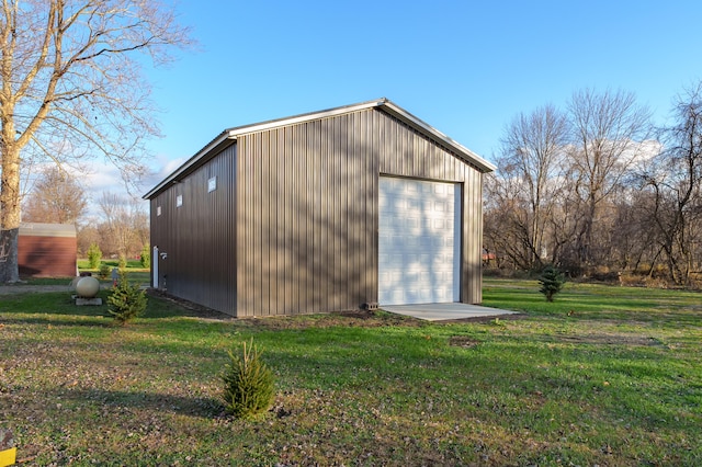 view of outbuilding with a lawn and a garage