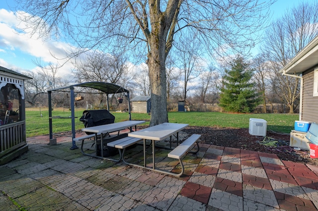 view of patio / terrace featuring area for grilling and a shed