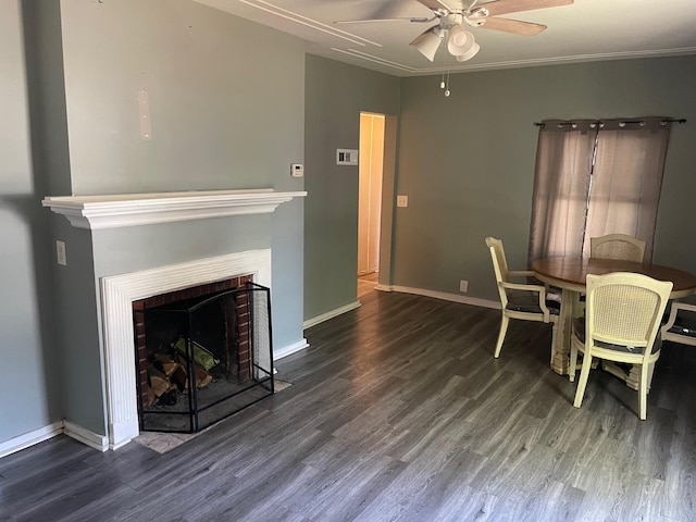 dining space with ornamental molding, a brick fireplace, ceiling fan, and hardwood / wood-style floors