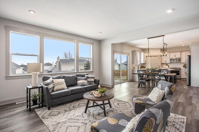 living room with dark hardwood / wood-style flooring and plenty of natural light