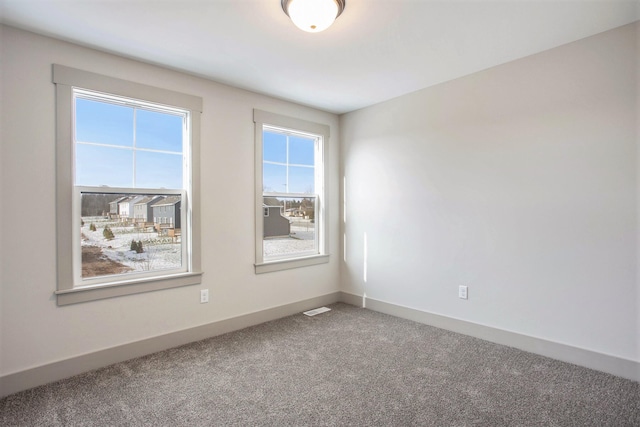 unfurnished room featuring carpet