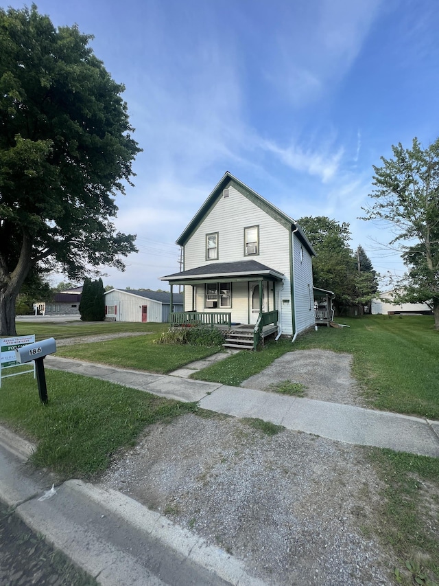 view of front facade with a front lawn and covered porch