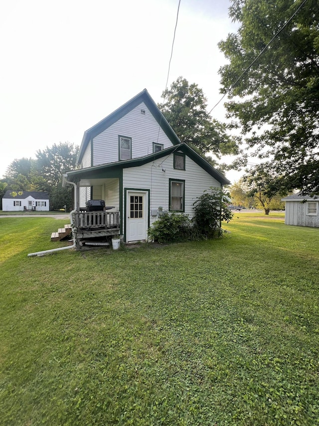 rear view of property with a yard