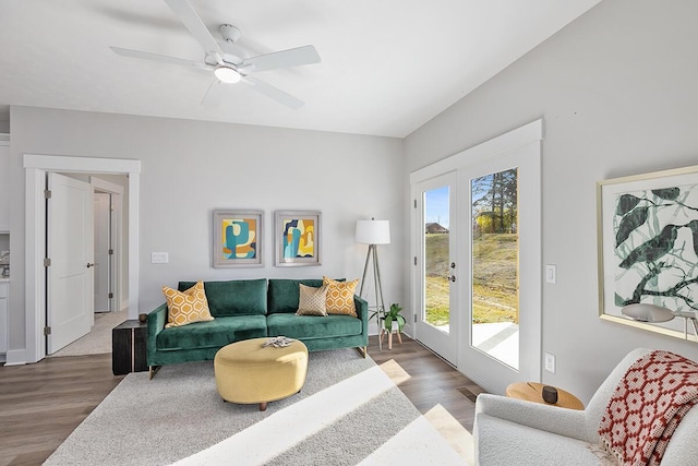 living room with dark wood-type flooring, ceiling fan, and french doors