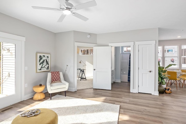 sitting room featuring hardwood / wood-style flooring and ceiling fan