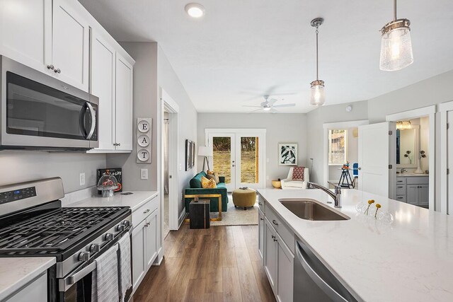 kitchen with white cabinets, ceiling fan, dark hardwood / wood-style floors, stainless steel appliances, and sink