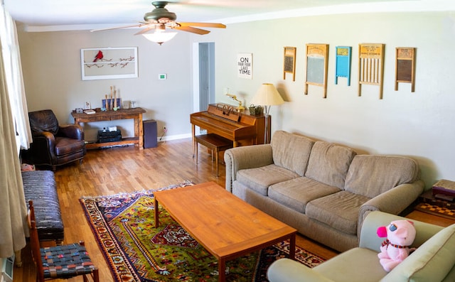 living room featuring ceiling fan, hardwood / wood-style flooring, and ornamental molding