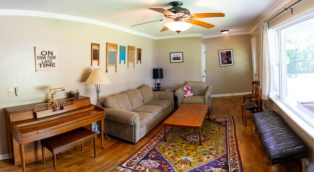 living room with ornamental molding, hardwood / wood-style flooring, and ceiling fan