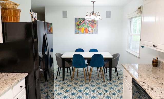 tiled dining room featuring a notable chandelier