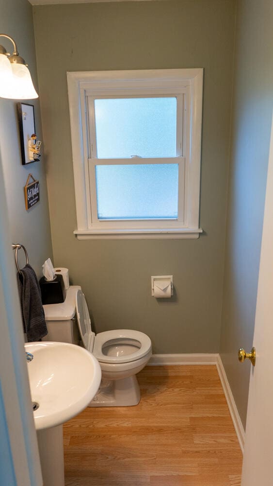 bathroom with hardwood / wood-style floors and toilet