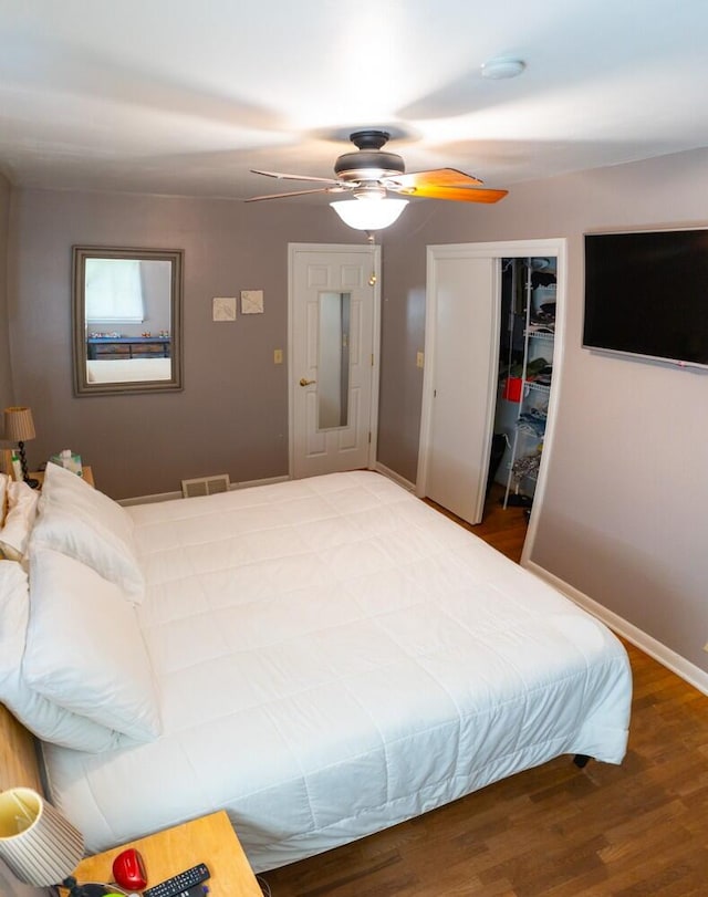 bedroom with a closet, wood-type flooring, and ceiling fan