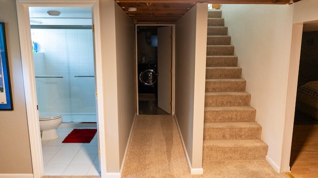 interior space with stacked washing maching and dryer and light tile patterned flooring