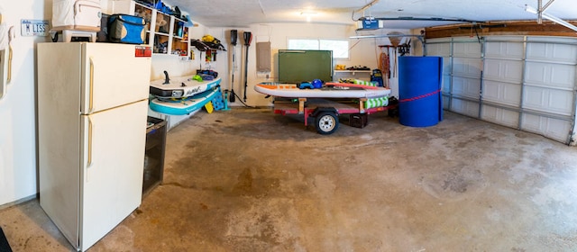 garage featuring a garage door opener and white refrigerator