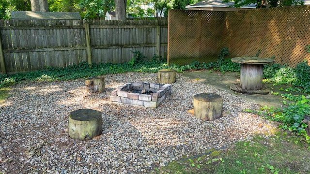 view of yard with a fire pit