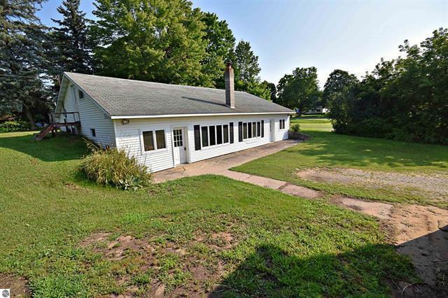 back of property with a yard and a chimney