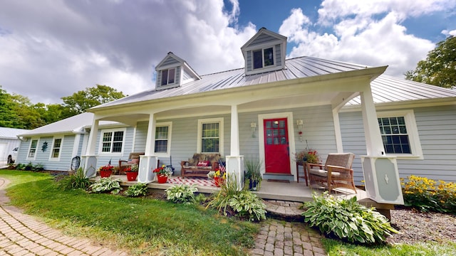 view of front of house with a porch and metal roof