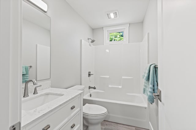 full bathroom with vanity, wood-type flooring, bathtub / shower combination, and toilet