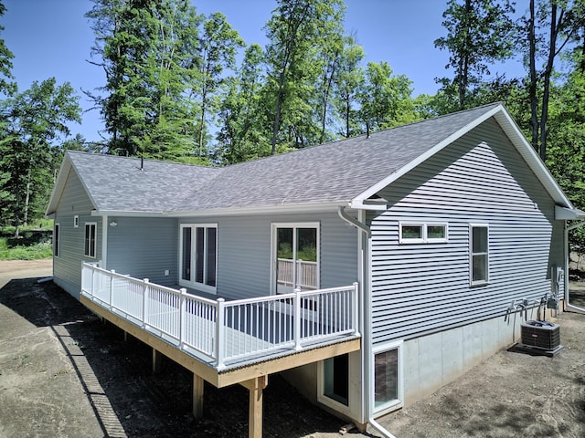 back of house featuring central AC and a deck