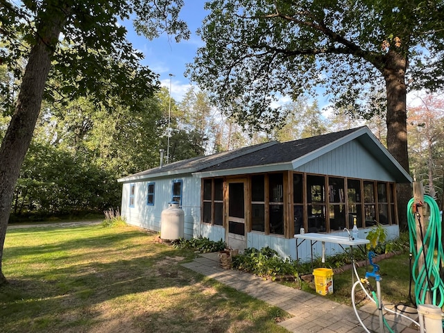 rear view of property with a lawn