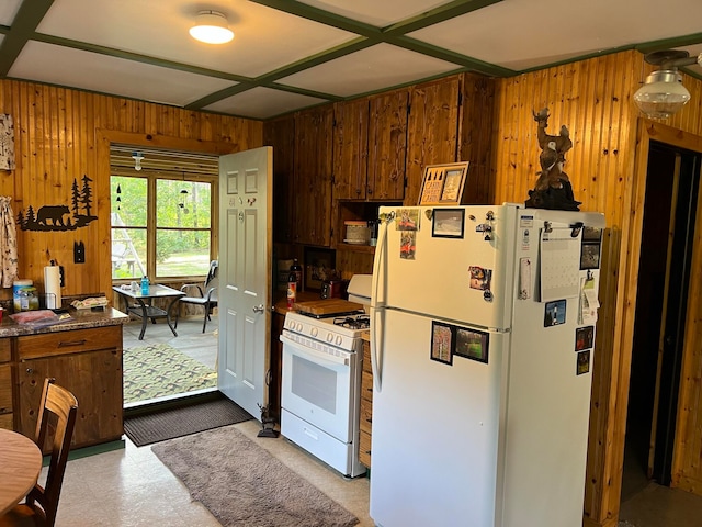 kitchen with wooden walls and white appliances