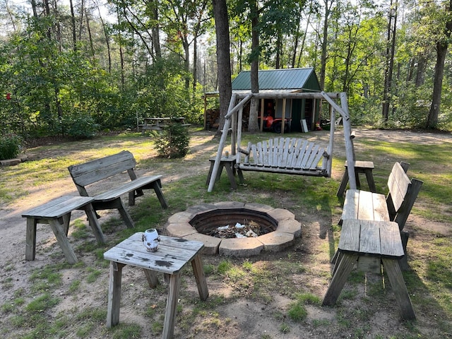 view of yard featuring an outdoor fire pit