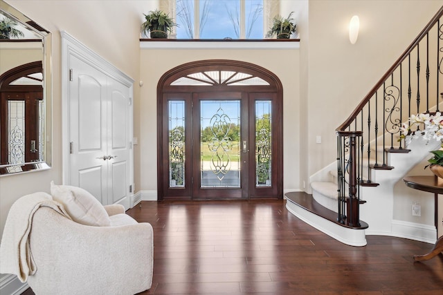 entrance foyer with a high ceiling and dark hardwood / wood-style floors