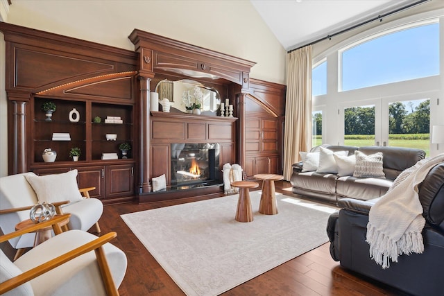 living room featuring high vaulted ceiling, french doors, and dark hardwood / wood-style flooring