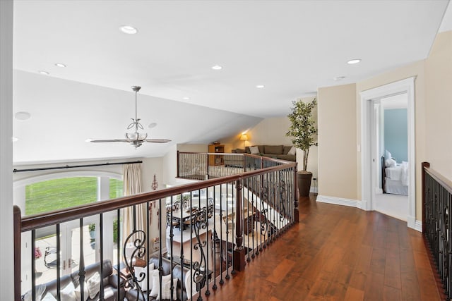 corridor with vaulted ceiling and dark hardwood / wood-style floors