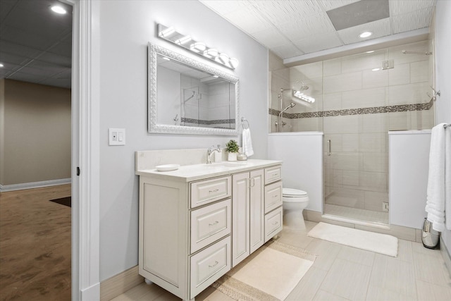 bathroom featuring an enclosed shower, vanity, and toilet