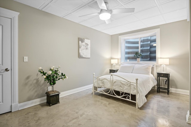 bedroom with ceiling fan and concrete flooring