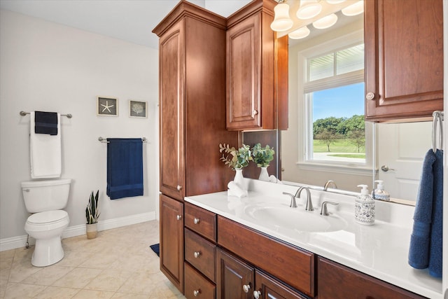 bathroom featuring toilet, vanity, and tile patterned flooring