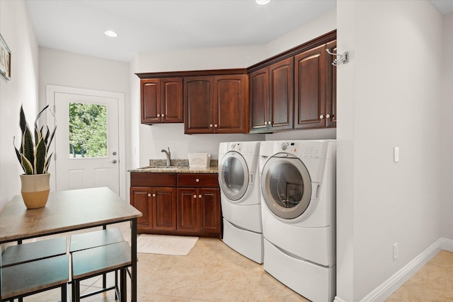 laundry area with cabinets, sink, washing machine and dryer, and light tile patterned flooring