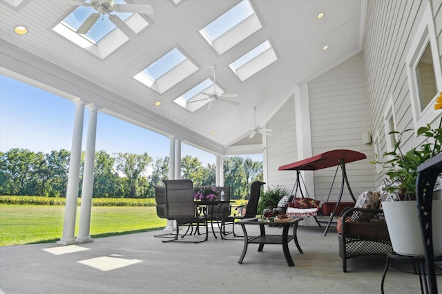 sunroom / solarium with ceiling fan and vaulted ceiling