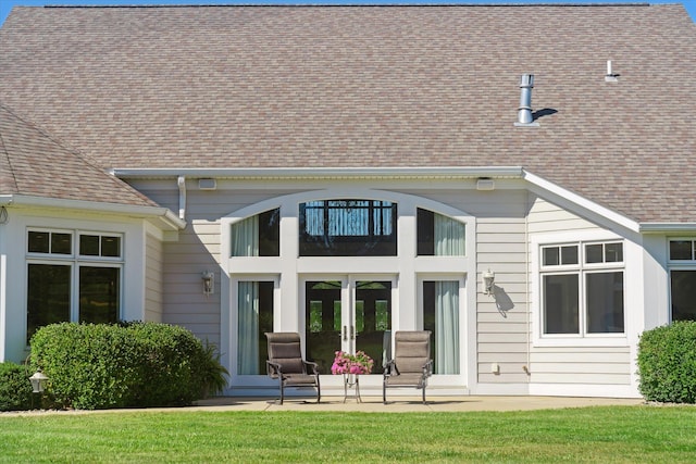 back of property featuring a lawn and a patio