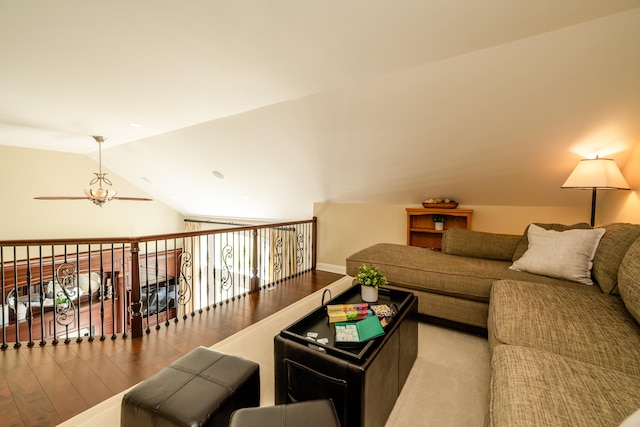 living room with vaulted ceiling, ceiling fan, and light wood-type flooring