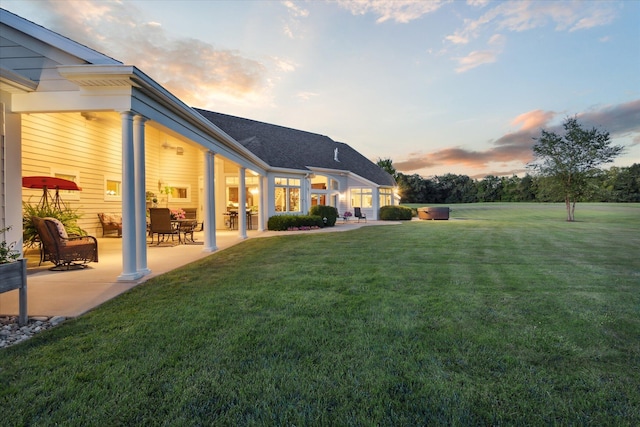 yard at dusk with a patio