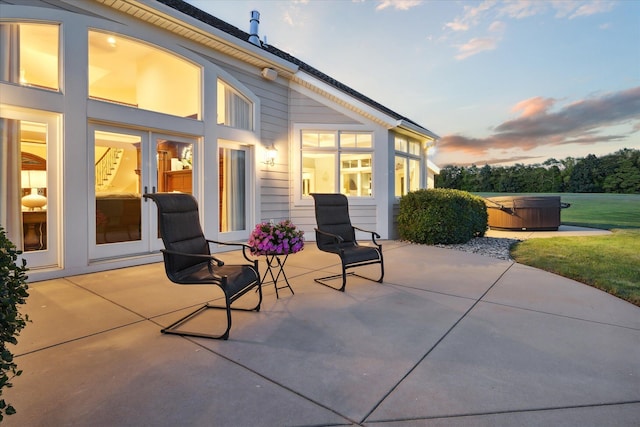 patio terrace at dusk with a hot tub