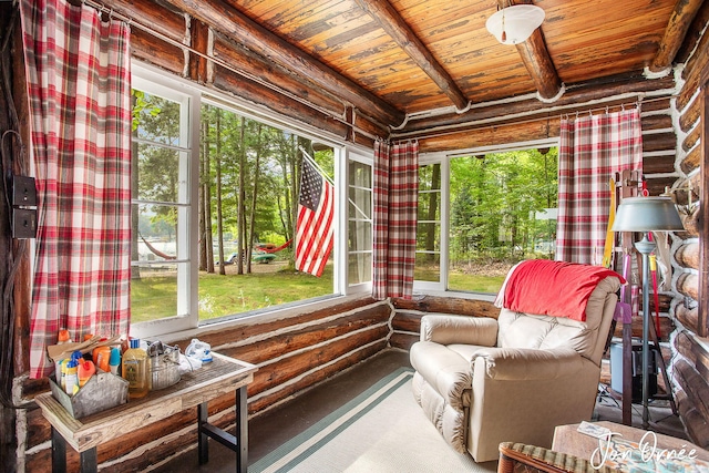 sunroom featuring beam ceiling, wood ceiling, and plenty of natural light